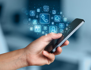 Hand holding smartphone with mobile app icons