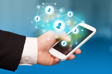 Finger pointing on smartphone, social network concept