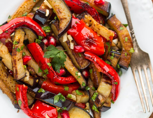 Salad of baked vegetables. Eggplant and bell peppers with pomegr