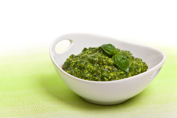 Basil Pesto on white background. Selective focus.