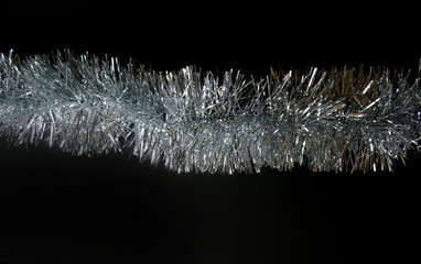 Christmas tinsel silver texture black background