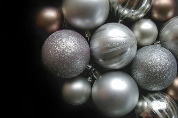 Silver Christmas baubles on black background
