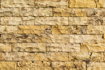 Old yellow-beige color brick wall