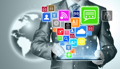 Business man using tablet PC with social media icon set