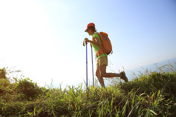  young woman hiking on seaside mountain trail