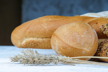 Bakery products and wheat ears on a table