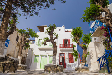 Small square of at Mykonos town with clear blue sky and trees, Greece