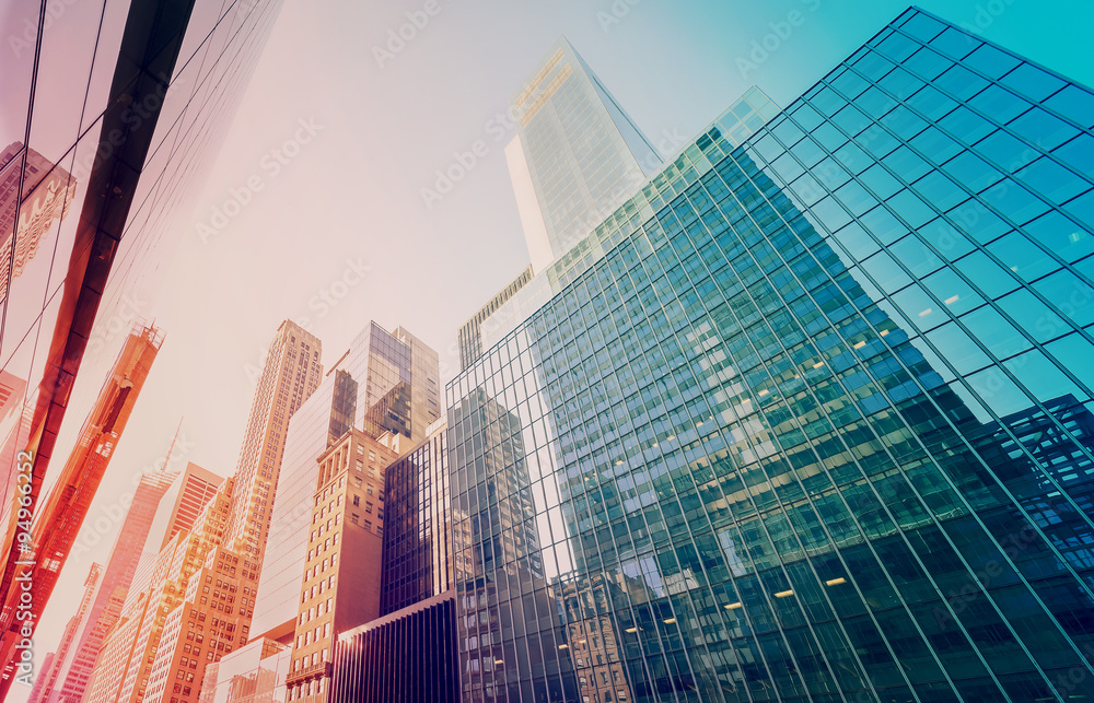 Wall mural vintage toned manhattan skyscrapers at sunset, nyc, usa