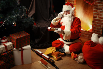 Portrait of happy Santa Claus sitting at his room at home