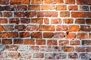 Old wall of broken red brick