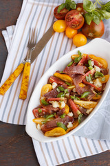 salad with parma ham (jamon) and  tomatoes 