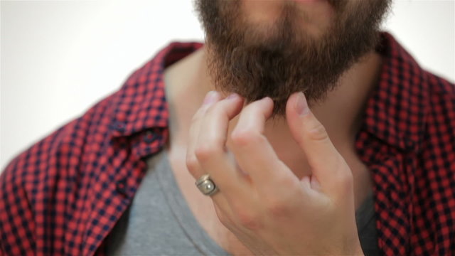 Closer portrait of man touching his perfect beard