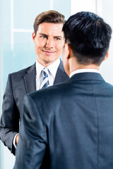 Business men talking in office discussing