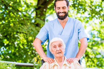 Geriatric nurse giving senior woman massage