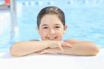 Child play at the pool place in a beautifull summer