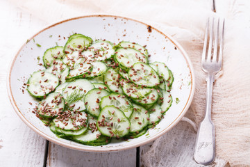   Cucumber salad with flax seeds.selective focus