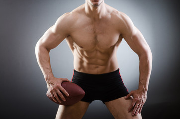 Fototapeta na wymiar Muscular man with american football