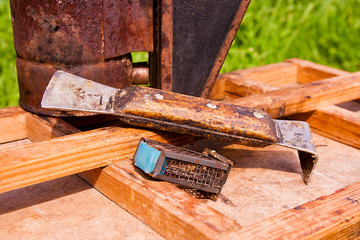 Old smoker and other tool of the beekeeper on the wooden box.