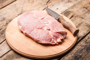 Big beefsteak with rural knife on wooden table