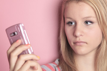 Teenage girl use cellphone in her room.