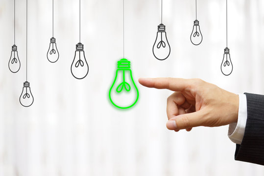 businessman choose green light bulb, idea & environment concept