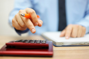 shallow depth of field of accountant calculating financial data