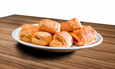 Fresh croissant in plate on a wooden background with clipping pa