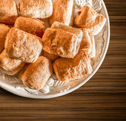 Fresh croissant in plate on a wooden background with clipping pa