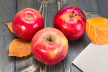 Winter red apples on a wooden table