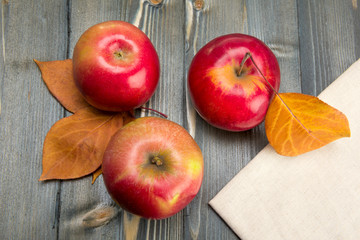 Winter red apples on a wooden table