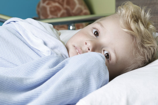 Sick Little Boy In A Hospital Bed