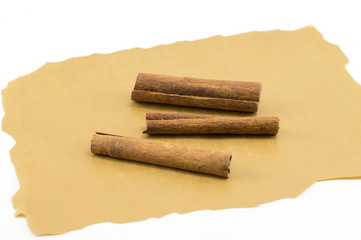 Cinnamon sticks on a brown cooking paper