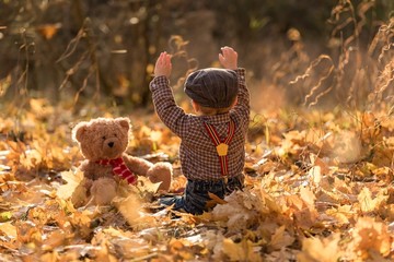 Little boy playing in autumnal forest © milosz_g