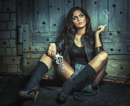 Brutal Girl with big gun, smoking.