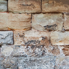 Limestone medieval wall of stone blocks texture background surface empty square closeup
