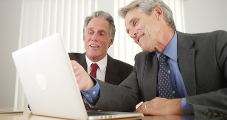 Two businessmen working on laptop in the office