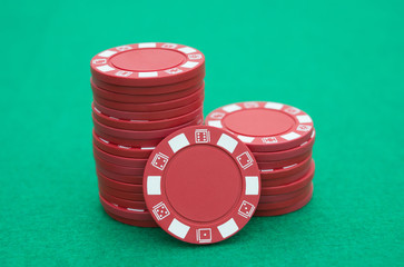 lots of red poker chips on casino table
