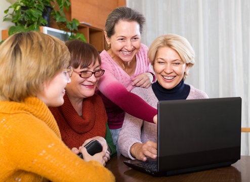 female pensioner studying laptop