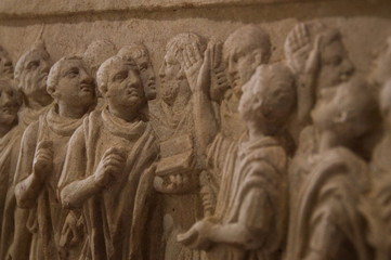 Old roman historic relief in stone of students with a teacher