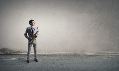 Handsome saxophonist. Concept image