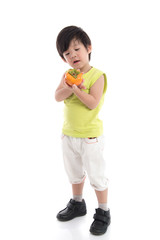 Cute asian boy holding persimmon
