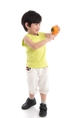 Cute asian boy holding persimmon