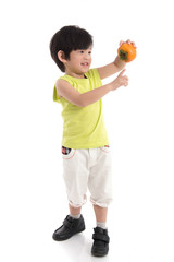 Cute asian boy holding persimmon