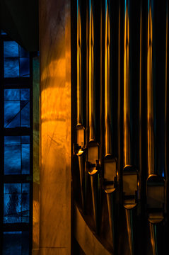 Dark artistic edit of a detail of an organ with blue stained gla
