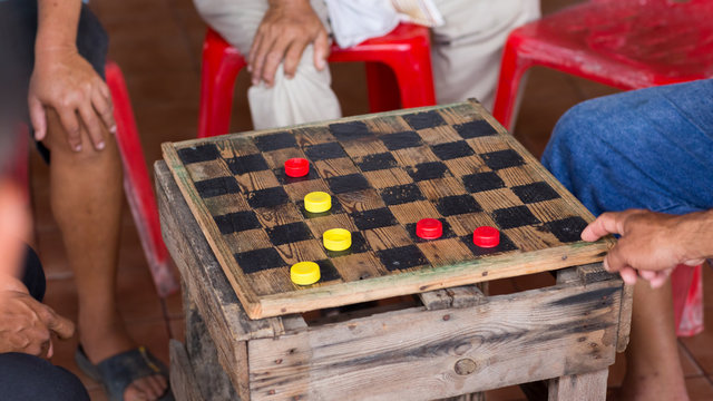 group of men are having fun  playing checker