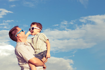 Father and son playing in the park  at the day time.