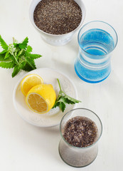 Chia seeds drink with a water, mint and lemon in a glass.