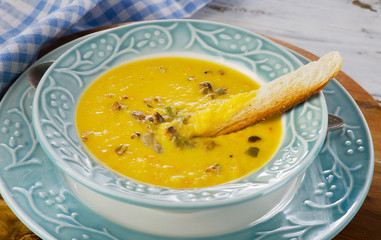 Bowl of pumpkin cream soup with crouton. Selective focus