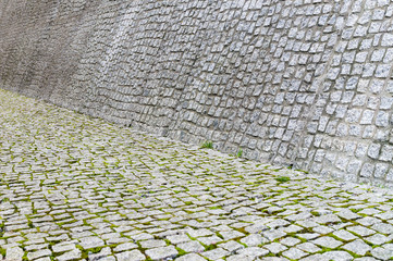 Cobblestone pavement and wall texture with moss