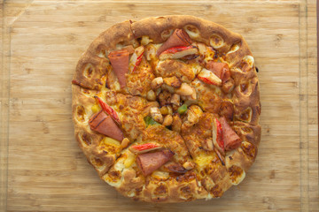 Hot Pizza Top View with Pineapple, Ham and Bell Pepper